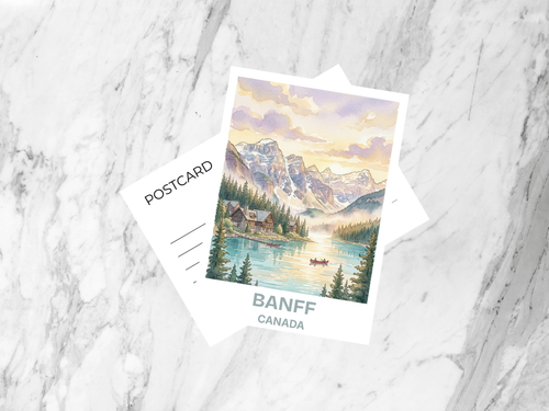 Postcard with a scenic illustration of Banff, Canada on a marble surface